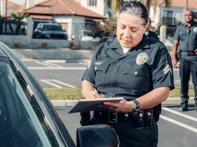 officer with a clip board writing